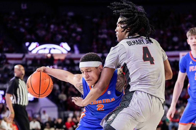 Feb 17, 2024; Athens, Georgia, USA; Florida Gators guard Riley Kugel (2) dribbles against Georgia Bulldogs guard Silas Demary Jr. (4) during the second half at Stegeman Coliseum. Mandatory Credit: Dale Zanine-USA TODAY Sports