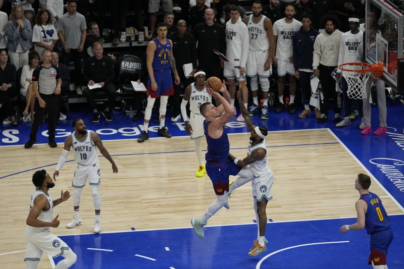 MINNEAPOLIS, MN -  MAY 16: Nikola Jokic #15 of the Denver Nuggets shoots the ball during the game against the Minnesota Timberwolves during Round 2 Game 6 of the 2024 NBA Playoffs on May 16, 2024 at Target Center in Minneapolis, Minnesota. NOTE TO USER: User expressly acknowledges and agrees that, by downloading and or using this Photograph, user is consenting to the terms and conditions of the Getty Images License Agreement. Mandatory Copyright Notice: Copyright 2024 NBAE (Photo by Jordan Johnson/NBAE via Getty Images)