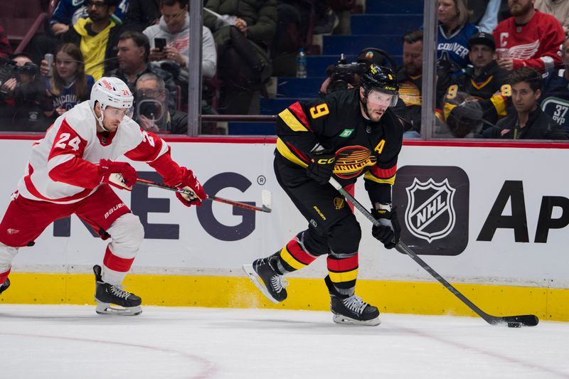 Feb 13, 2023; Vancouver, British Columbia, CAN; Detroit Red Wings forward Pius Suter (24) skates after Vancouver Canucks forward J.T. Miller (9) in the second period at Rogers Arena. Mandatory Credit: Bob Frid-USA TODAY Sports