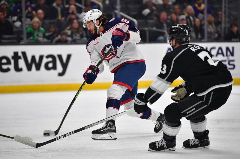 Mar 16, 2023; Los Angeles, California, USA; Columbus Blue Jackets right wing Kirill Marchenko (86) shoots against the defense of Los Angeles Kings defenseman Matt Roy (3) during the first period at Crypto.com Arena. Mandatory Credit: Gary A. Vasquez-USA TODAY Sports