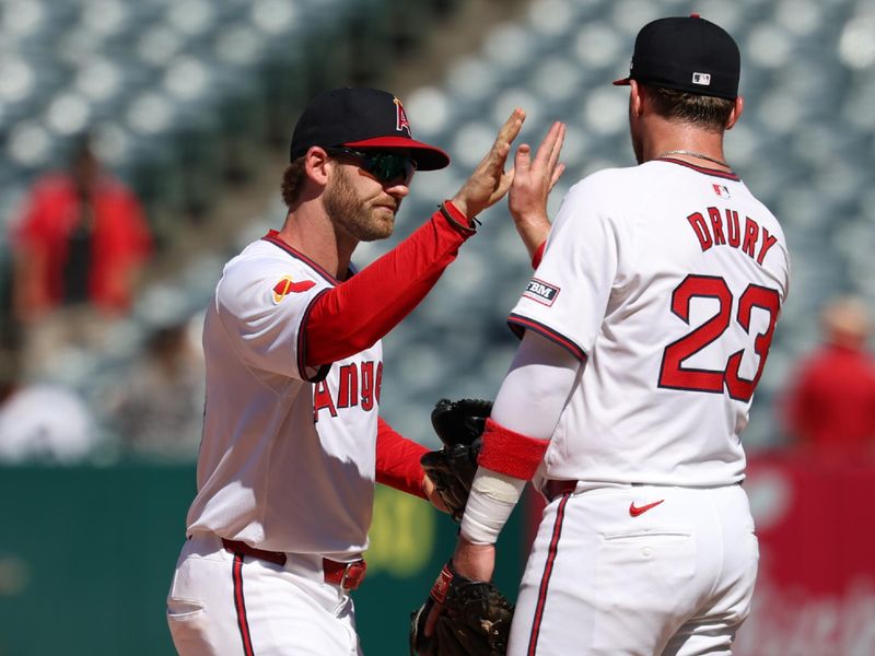 Jul 28, 2024; Anaheim, California, USA;  Los Angeles Angels left fielder Taylor Ward (3) and second baseman Brandon Drury (23) celebrate a victory after defeating the Oakland Athletics 8-6 at Angel Stadium. Mandatory Credit: Kiyoshi Mio-USA TODAY Sports