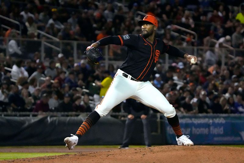 Mar 19, 2024; Scottsdale, Arizona, USA; San Francisco Giants pitcher Amir Garrett (18) throws against the Kansas City Royals in the third inning at Scottsdale Stadium. Mandatory Credit: Rick Scuteri-USA TODAY Sports