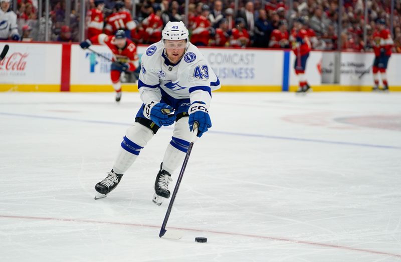Dec 27, 2025; Sunrise, Florida, USA; Tampa Bay Lightning defenseman Darren Raddysh (43) moves the puck against the Florida Panthers during the first period at Amerant Bank Arena. Mandatory Credit: Jeff Romance-Imagn Images