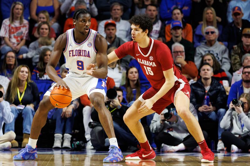 Feb 1, 2026; Gainesville, Florida, USA; Florida Gators center Rueben Chinyelu (9) posts up against Alabama Crimson Tide center Noah Williamson (15) during the first half at Exactech Arena at the Stephen C. O'Connell Center. Mandatory Credit: Matt Pendleton-Imagn Images