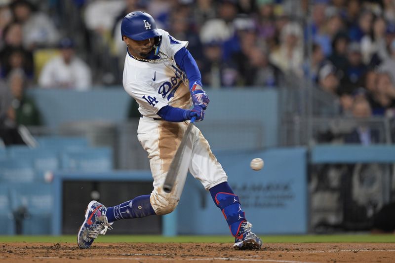 Apr 2, 2024; Los Angeles, California, USA; Los Angeles Dodgers shortstop Mookie Betts (50) hits a solo home run for his 1500th career hit in the third inning against the San Francisco Giants at Dodger Stadium. Mandatory Credit: Jayne Kamin-Oncea-USA TODAY Sports