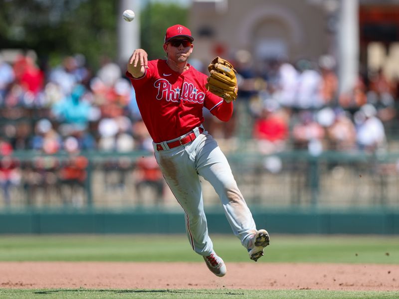 Mar 26, 2023; Sarasota, Florida, USA;  Philadelphia Phillies shortstop Scott Kingery (4) throws to first against the Baltimore Orioles in the fourth inning during spring training at Ed Smith Stadium. Mandatory Credit: Nathan Ray Seebeck-USA TODAY Sports