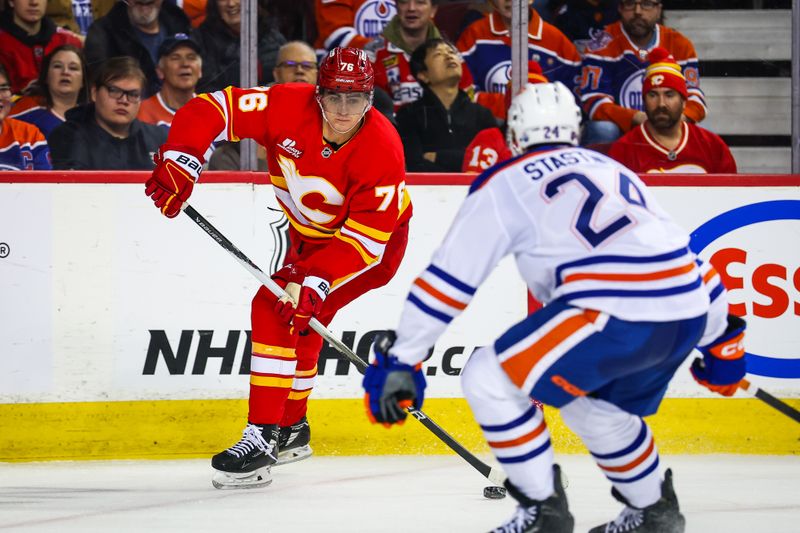Feb 4, 2026; Calgary, Alberta, CAN; Calgary Flames center Martin Pospisil (76) controls the puck against Edmonton Oilers defenseman Spencer Stastney (24) during the second period at Scotiabank Saddledome. Mandatory Credit: Sergei Belski-Imagn Images