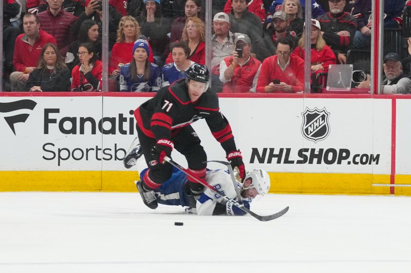 Feb 26, 2026; Raleigh, North Carolina, USA;  Carolina Hurricanes left wing Taylor Hall (71) and Tampa Bay Lightning right wing Nikita Kucherov (86) battle over the puck during the third period at Lenovo Center. Mandatory Credit: James Guillory-Imagn Images