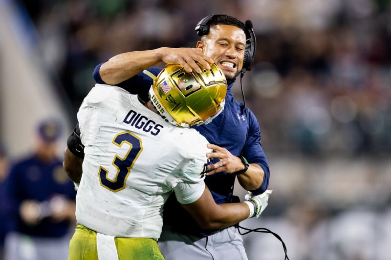 Dec 30, 2022; Jacksonville, FL, USA; Notre Dame Fighting Irish head coach Marcus Freeman celebrates a touchdown with Notre Dame Fighting Irish running back Logan Diggs (3) during the second half against the South Carolina Gamecocks in the 2022 Gator Bowl at TIAA Bank Field. Mandatory Credit: Matt Pendleton-USA TODAY Sports