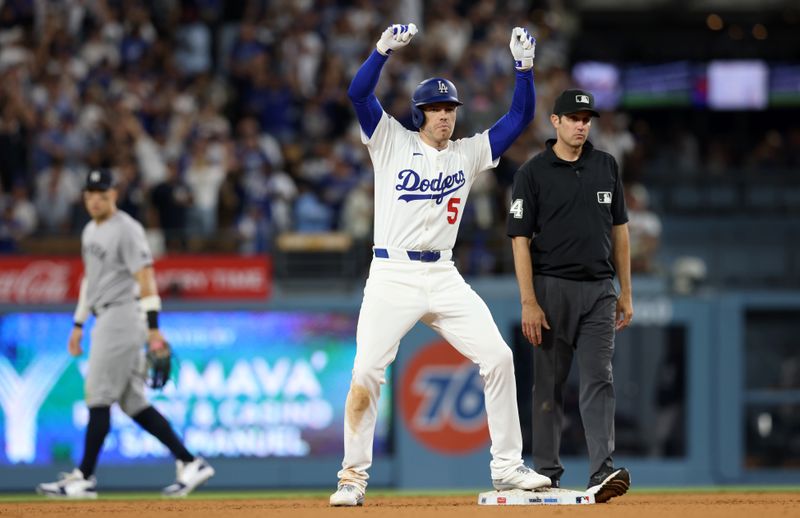 May 30, 2025; Los Angeles, California, USA; Los Angeles Dodgers first baseman Freddie Freeman (5) celebrates after hitting a RBI double during the sixth inning against the New York Yankees at Dodger Stadium. Mandatory Credit: Jason Parkhurst-Imagn Images