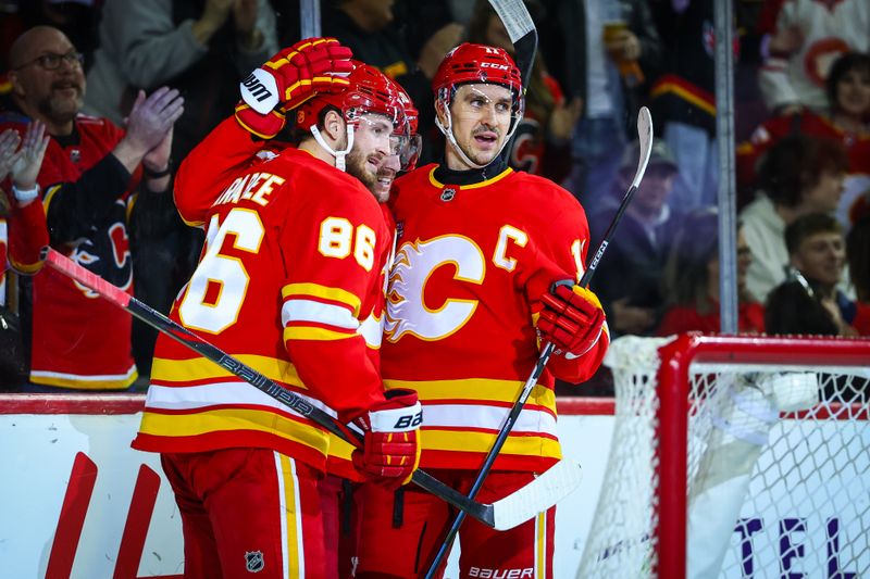 Mar 20, 2026; Calgary, Alberta, CAN; Calgary Flames left wing Joel Farabee (86) celebrates his goal with teammates against the Florida Panthers during the second period at Scotiabank Saddledome. Mandatory Credit: Sergei Belski-Imagn Images
