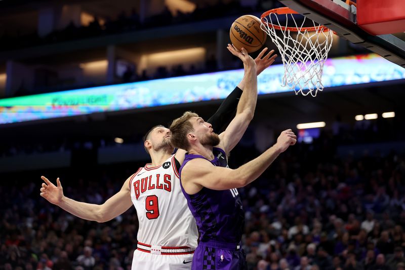 SACRAMENTO, CALIFORNIA - MARCH 04: Domantas Sabonis #10 of the Sacramento Kings goes up for a shot on Nikola Vucevic #9 of the Chicago Bulls in the second half at Golden 1 Center on March 04, 2024 in Sacramento, California. NOTE TO USER: User expressly acknowledges and agrees that, by downloading and or using this photograph, User is consenting to the terms and conditions of the Getty Images License Agreement.  (Photo by Ezra Shaw/Getty Images)