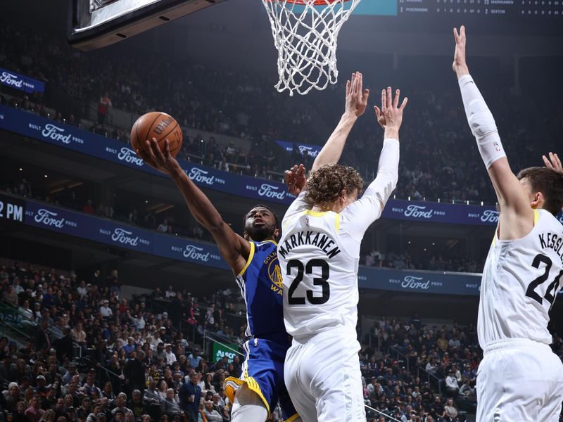 SALT LAKE CITY, UT - FEBRUARY 15: Andrew Wiggins #22 of the Golden State Warriors drives to the basket against Lauri Markkanen #23 and Walker Kessler #24 of the Utah Jazz during the game on February 15, 2024 at Delta Center in Salt Lake City, Utah. NOTE TO USER: User expressly acknowledges and agrees that, by downloading and or using this Photograph, User is consenting to the terms and conditions of the Getty Images License Agreement. Mandatory Copyright Notice: Copyright 2024 NBAE (Photo by Melissa Majchrzak/NBAE via Getty Images)