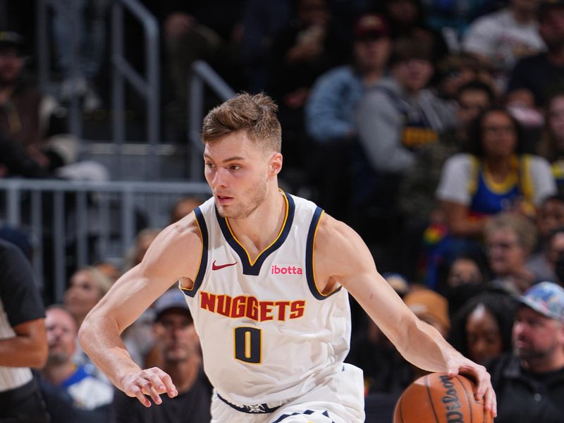 DENVER, CO - OCTOBER 13: Christian Braun #0 of the Denver Nuggets dribbles the ball during the game against the Phoenix Suns on October 13, 2024 at Ball Arena in Denver, Colorado. NOTE TO USER: User expressly acknowledges and agrees that, by downloading and/or using this Photograph, user is consenting to the terms and conditions of the Getty Images License Agreement. Mandatory Copyright Notice: Copyright 2024 NBAE (Photo by Garrett Ellwood/NBAE via Getty Images)