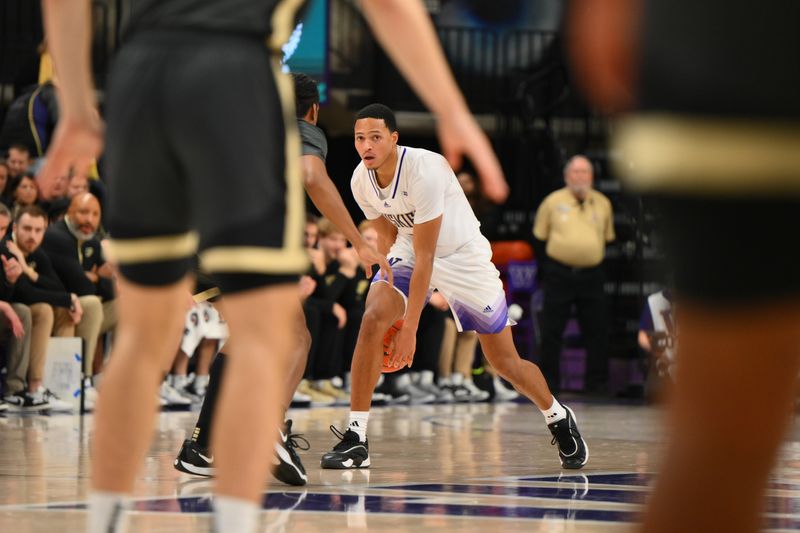 Jan 15, 2025; Seattle, Washington, USA; Washington Huskies guard Tyree Ihenacho (6) dribbles the ball during the second half against the Purdue Boilermakers at Alaska Airlines Arena at Hec Edmundson Pavilion. Mandatory Credit: Steven Bisig-Imagn Images