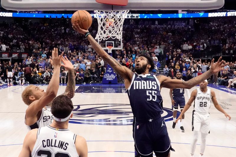 DALLAS, TEXAS - DECEMBER 23: Derrick Jones Jr. #55 of the Dallas Mavericks reaches for a rebound over Jeremy Sochan #10 of the San Antonio Spurs \d1h at American Airlines Center on December 23, 2023 in Dallas, Texas. NOTE TO USER: User expressly acknowledges and agrees that, by downloading and or using this photograph, User is consenting to the terms and conditions of the Getty Images License Agreement. (Photo by Sam Hodde/Getty Images)