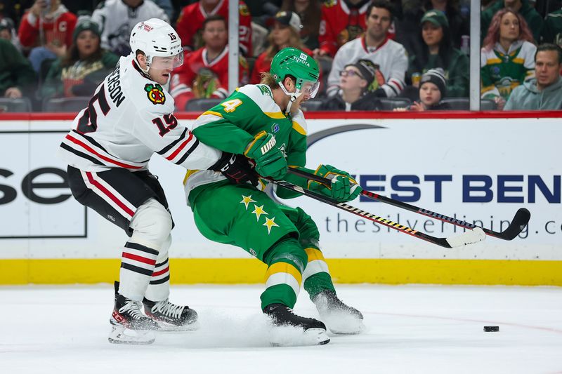 Dec 3, 2023; Saint Paul, Minnesota, USA; Minnesota Wild defenseman Jon Merrill (4) and Chicago Blackhawks right wing Joey Anderson (15) compete for the puck during the first period at Xcel Energy Center. Mandatory Credit: Matt Krohn-USA TODAY Sports