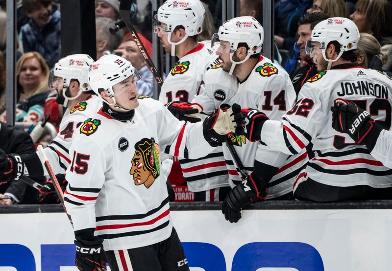 Jan 24, 2024; Seattle, Washington, USA; Chicago Blackhawks forward Joey Anderson (15) is congratulated by teammates on the bench after scoring a goal during the first period against the Seattle Kraken at Climate Pledge Arena. Mandatory Credit: Stephen Brashear-USA TODAY Sports