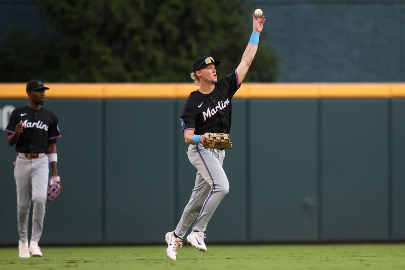 Aug 3, 2024; Atlanta, Georgia, USA; Miami Marlins left fielder Kyle Stowers (28) throws the ball against the Atlanta Braves in the second inning at Truist Park. Mandatory Credit: Brett Davis-USA TODAY Sports