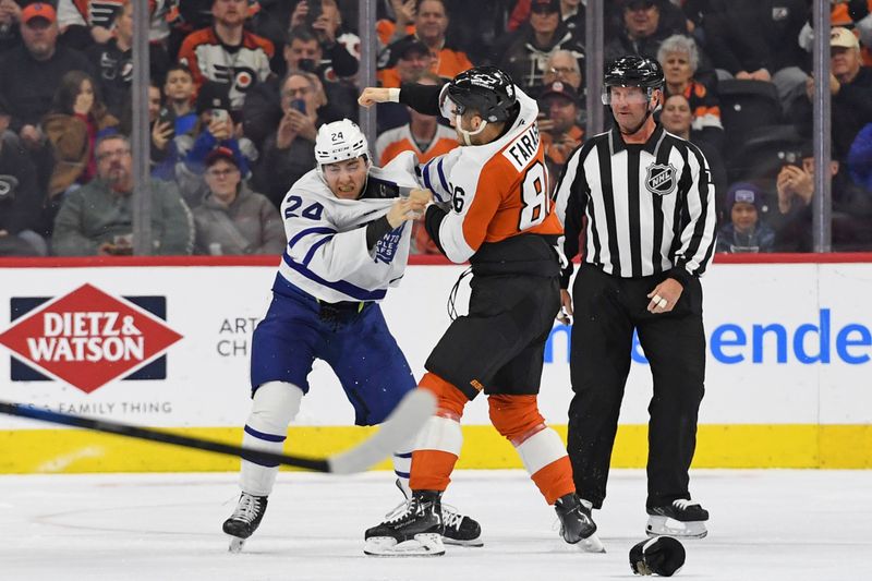 Jan 7, 2025; Philadelphia, Pennsylvania, USA; Toronto Maple Leafs center Connor Dewar (24) and Philadelphia Flyers left wing Joel Farabee (86) fight during the first period at Wells Fargo Center. Mandatory Credit: Eric Hartline-Imagn Images