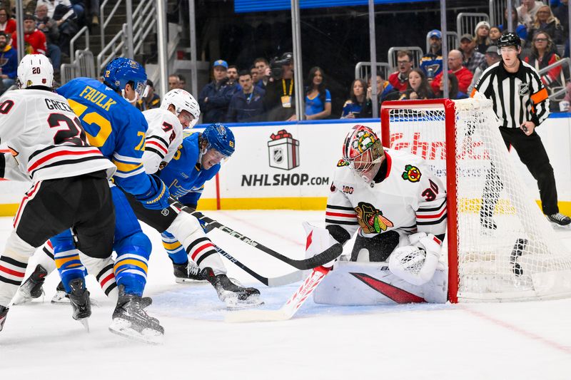 Dec 12, 2025; St. Louis, Missouri, USA; St. Louis Blues defenseman Justin Faulk (72) shoots and scores against Chicago Blackhawks goaltender Spencer Knight (30) during the second period at Enterprise Center. Mandatory Credit: Jeff Curry-Imagn Images