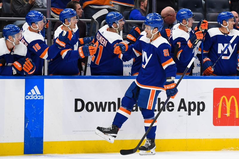 Oct 18, 2022; Elmont, New York, USA; New York Islanders defenseman Alexander Romanov (28) celebrates his goal against the San Jose Sharks with the New York Islanders bench during the third period at UBS Arena. Mandatory Credit: Dennis Schneidler-USA TODAY Sports