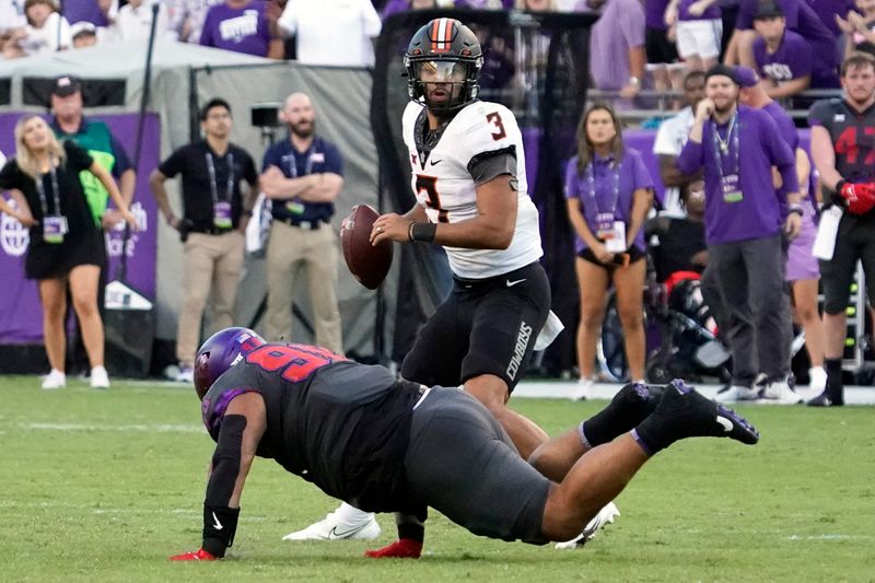 Oct 15, 2022; Fort Worth, Texas, USA; Oklahoma State Cowboys quarterback Spencer Sanders (3) elludes the pressure by TCU Horned Frogs defensive lineman Dylan Horton (98) during overtime at Amon G. Carter Stadium. Mandatory Credit: Raymond Carlin III-USA TODAY Sports