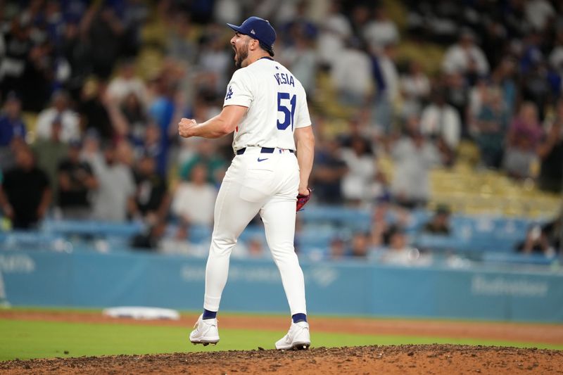 Aug 21, 2024; Los Angeles, California, USA; Los Angeles Dodgers relief pitcher Alex Vesia (51) reacts at the end of the game against the Seattle Mariners at Dodger Stadium. Mandatory Credit: Kirby Lee-USA TODAY Sports