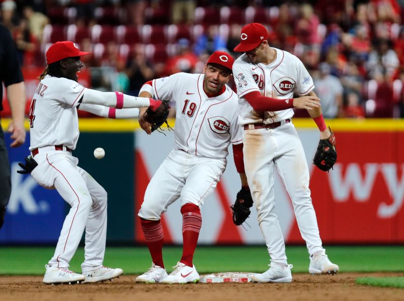 Aug 7, 2023; Cincinnati, Ohio, USA; Cincinnati Reds shortstop Elly De La Cruz (44) first baseman Joey Votto (19) and second Kevin Newman (28) react after the Reds defeated the Miami Marlins at Great American Ball Park. Mandatory Credit: David Kohl-USA TODAY Sports