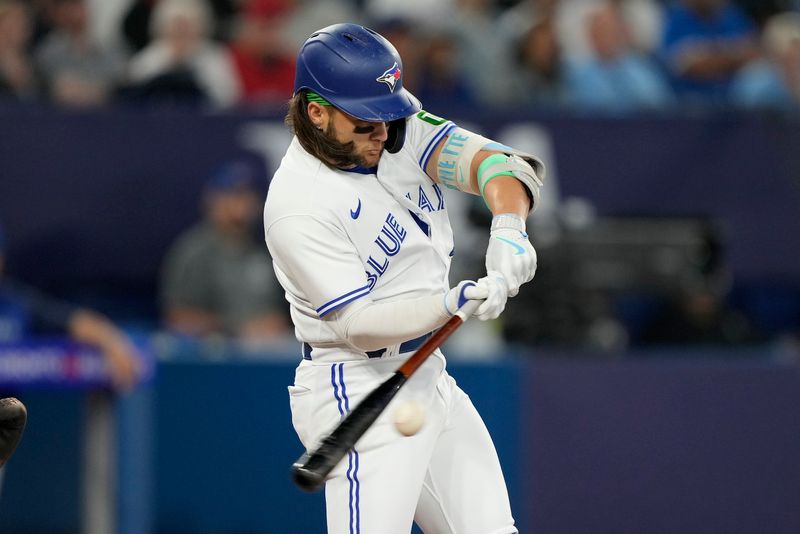 Sep 8, 2023; Toronto, Ontario, CAN; Toronto Blue Jays shortstop Bo Bichette (11) hits an RBI double against the Kansas City Royals during the sixth inning at Rogers Centre. Mandatory Credit: John E. Sokolowski-USA TODAY Sports