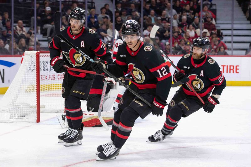 Oct 17, 2024; Ottawa, Ontario, CAN; Ottawa Senators defenseman Thomas Chabot (72) and center Shane Pinto (12) and right wing Claude Giroux (28) skate by following a goal scored by the New Jersey Devils in the second period at the Canadian Tire Centre. Mandatory Credit: Marc DesRosiers-Imagn Images