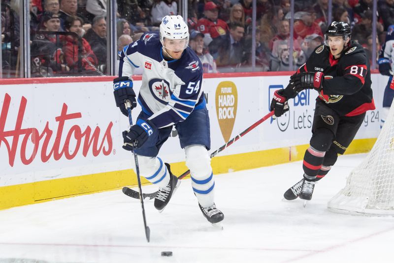 Jan 20, 2024; Ottawa, Ontario, CAN; Winnipeg Jets defenseman Dylan Samberg (54) skates with the puck in the first period against the Ottawa Senators at the Canadian Tire Centre. Mandatory Credit: Marc DesRosiers-USA TODAY Sports