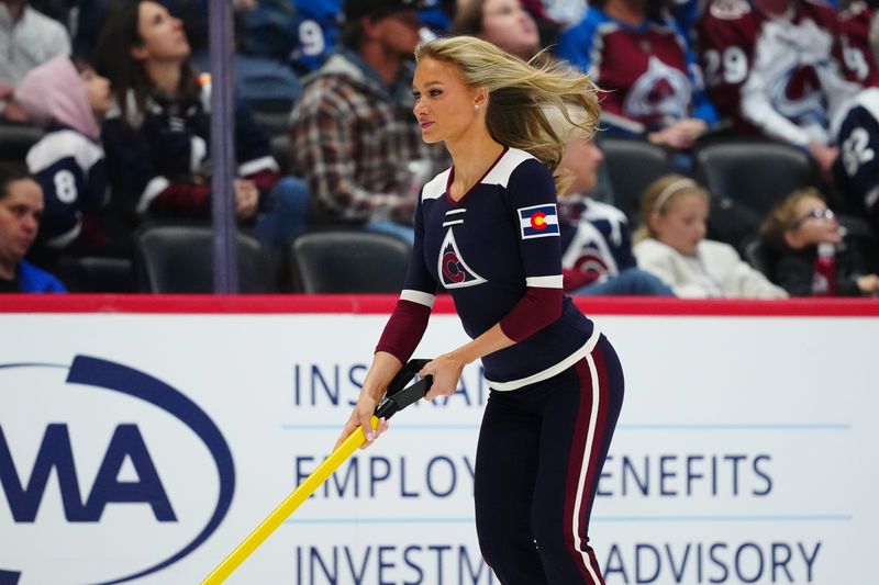 Jan 16, 2026; Denver, Colorado, USA; Colorado Avalanche ice patrol Sydney Browne clears the rink in the third period against the Nashville Predators at Ball Arena. Mandatory Credit: Ron Chenoy-Imagn Images