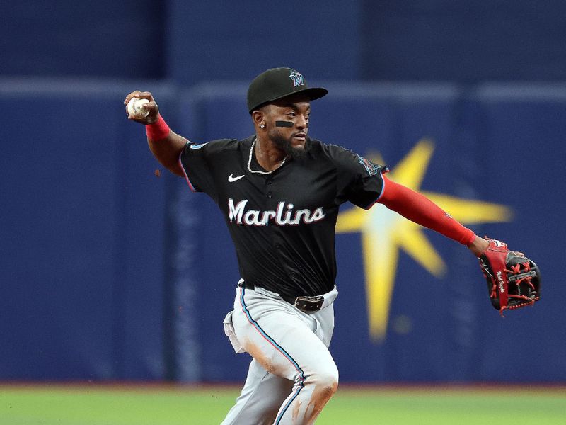Jul 31, 2024; St. Petersburg, Florida, USA;  Miami Marlins shortstop Vidal Brujan (17) throws the ball to first base for an out against the Tampa Bay Rays during the ninth inning at Tropicana Field. Mandatory Credit: Kim Klement Neitzel-USA TODAY Sports