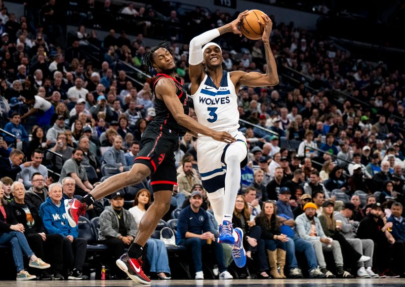 MINNEAPOLIS, MINNESOTA - APRIL 3: Immanuel Quickley #5 of the Toronto Raptors collides with Jaden McDaniels #3 of the Minnesota Timberwolves as he gathers the ball in the third quarter of the game at Target Center on April 3, 2024 in Minneapolis, Minnesota. NOTE TO USER: User expressly acknowledges and agrees that, by downloading and or using this photograph, User is consenting to the terms and conditions of the Getty Images License Agreement. (Photo by Stephen Maturen/Getty Images)