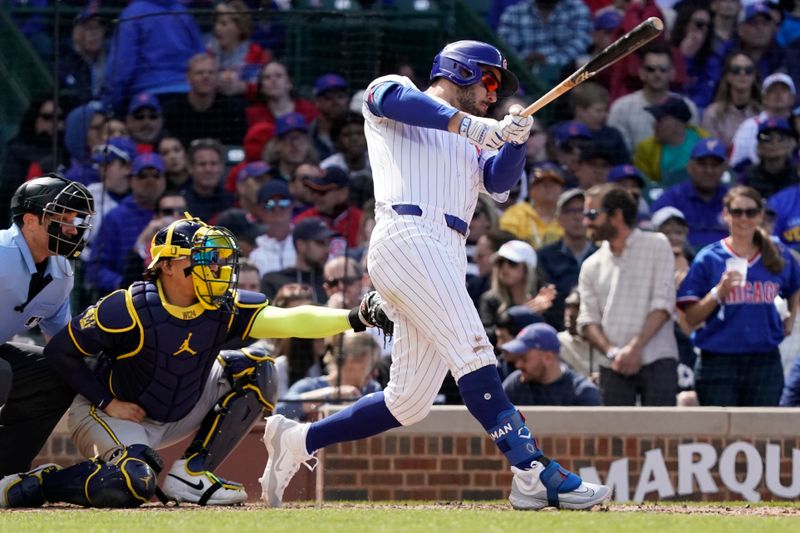 May 5, 2024; Chicago, Illinois, USA; Chicago Cubs outfielder Mike Tauchman (40) hits a single against the Milwaukee Brewers during the eighth inning at Wrigley Field. Mandatory Credit: David Banks-USA TODAY Sports