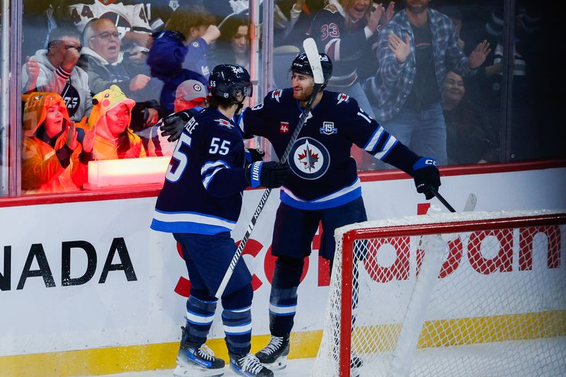 Oct 30, 2025; Winnipeg, Manitoba, CAN;  Winnipeg Jets forward Gabriel Vilardi (13) is congratulated by Winnipeg Jets forward Mark Scheifele (55) for scoring a goal against Chicago Blackhawks goalie Spencer Knight (30) during the first period at Canada Life Centre. Mandatory Credit: Terrence Lee-Imagn Images