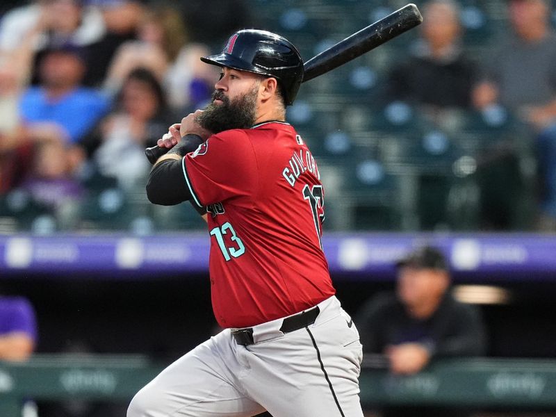 Sep 17, 2024; Denver, Colorado, USA; Arizona Diamondbacks second base Luis Guillorme (13) hits a sacrifice fly in the second inning against the Colorado Rockies at Coors Field. Mandatory Credit: Ron Chenoy-Imagn Images