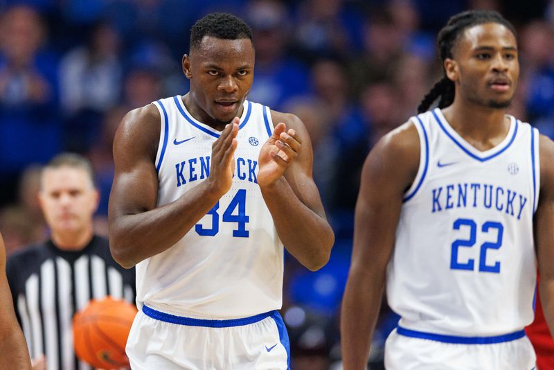 Dec 31, 2022; Lexington, Kentucky, USA; Kentucky Wildcats forward Oscar Tshiebwe (34) celebrates as he walks back to the bench during the first half against the Louisville Cardinals at Rupp Arena at Central Bank Center. Mandatory Credit: Jordan Prather-USA TODAY Sports