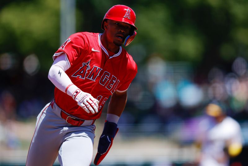 May 22, 2025; West Sacramento, California, USA; Los Angeles Angels center fielder Kyren Paris (19) rounds third base to score on an RBI double by shortstop Zach Neto (9) during the fifth inning against the Athletics at Sutter Health Park. Mandatory Credit: Sergio Estrada-Imagn Images