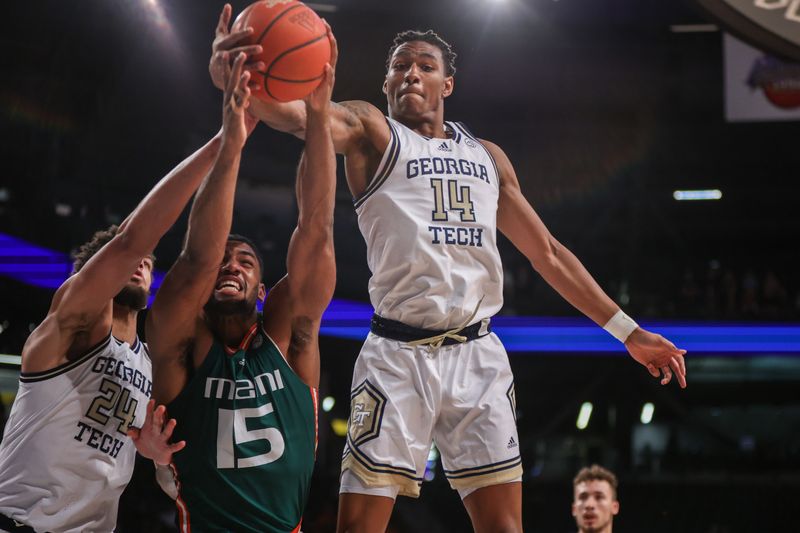 Jan 4, 2023; Atlanta, Georgia, USA; Georgia Tech Yellow Jackets forward Jalon Moore (14) and center Rodney Howard (24) reach for a rebound with Miami Hurricanes forward Norchad Omier (15) in the first half at McCamish Pavilion. Mandatory Credit: Brett Davis-USA TODAY Sports
