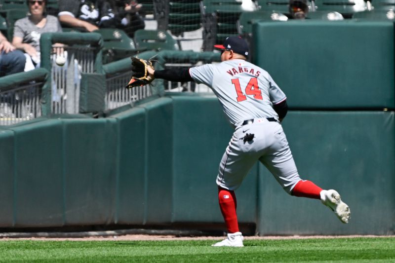 May 15, 2024; Chicago, Illinois, USA;  Washington Nationals second baseman Ildemaro Vargas (14) tries to make the play on the double hit by Chicago White Sox outfielder Andrew Benintendi (not shown) during the sixth inning at Guaranteed Rate Field. Mandatory Credit: Matt Marton-USA TODAY Sports