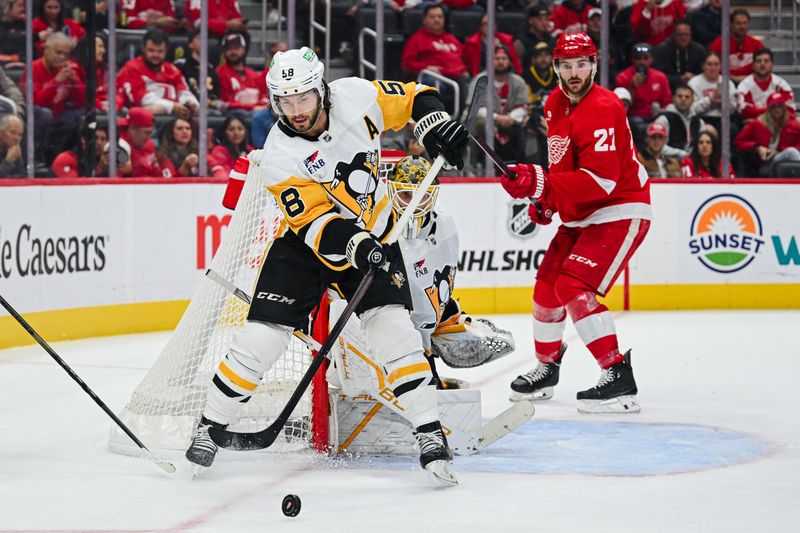 Oct 10, 2024; Detroit, Michigan, USA; Pittsburgh Penguins defenseman Kris Letang (58) clears the puck during the game against the Detroit Red Wings at Little Caesars Arena. Mandatory Credit: Tim Fuller-Imagn Images