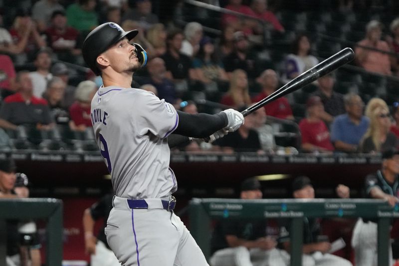 Aug 14, 2024; Phoenix, Arizona, USA; Colorado Rockies outfielder Brenton Doyle (9) hits against the Arizona Diamondbacks in the first inning at Chase Field. Mandatory Credit: Rick Scuteri-USA TODAY Sports