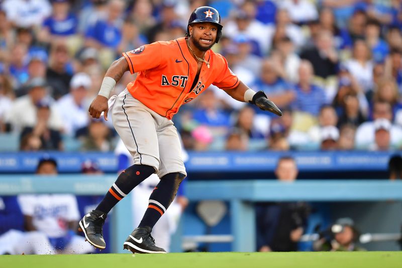 Jun 25, 2023; Los Angeles, California, USA; Houston Astros designated hitter Corey Julks (9) is caught in a run down against the Los Angeles Dodgers during the tenth inning at Dodger Stadium. Mandatory Credit: Gary A. Vasquez-USA TODAY Sports