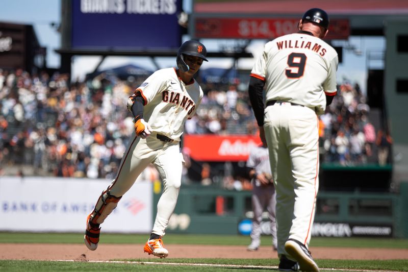 May 14, 2025; San Francisco, California, USA; San Francisco Giants center fielder Jung Hoo Lee (left) gets a congratulatory handshake from third base coach Matt Williams (9) after hitting a two-run home run against the Arizona Diamondbacks during the seventh inning at Oracle Park. Mandatory Credit: D. Ross Cameron-Imagn Images