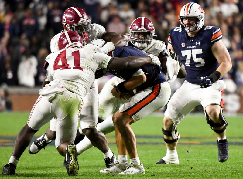 Nov 25, 2023; Auburn, Alabama, USA;  Alabama Crimson Tide linebacker Dallas Turner (15) and linebacker Chris Braswell (41) sack Auburn Tigers quarterback Payton Thorne (1) for a loss at Jordan-Hare Stadium. Alabama won 27-24. Mandatory Credit: Gary Cosby Jr.-USA TODAY Sports