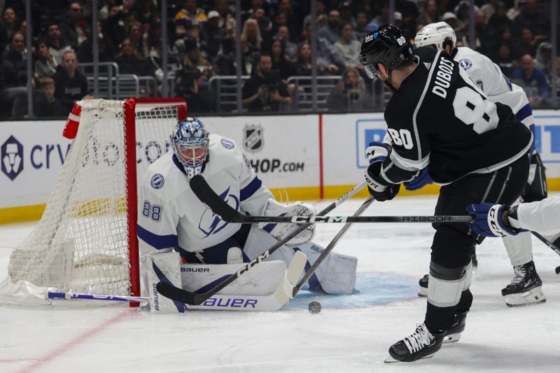 Mar 23, 2024; Los Angeles, California, USA; Tampa Bay Lighting goalie Andrei Vasilevskiy (88) blocks a shot by Los Angeles Kings Center Pierre-Luc Dubois (80) during the second period of an NHL hockey game at Crypto.com Arena. Mandatory Credit: Yannick Peterhans-USA TODAY Sports