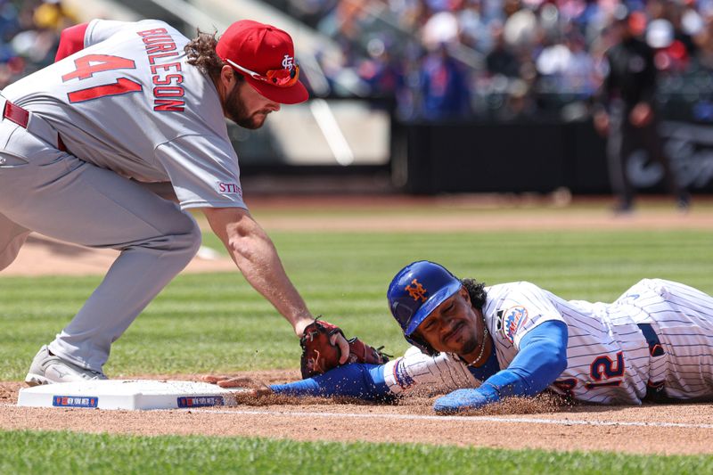 Apr 20, 2025; New York City, New York, USA; New York Mets shortstop Francisco Lindor (12) slides safely back to first base asSt. Louis Cardinals first baseman Alec Burleson (41) tags during the third inning at Citi Field. Mandatory Credit: Vincent Carchietta-Imagn Images