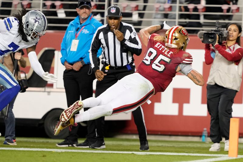 San Francisco 49ers tight end George Kittle (85) dives toward the sideline against the Dallas Cowboys during the second half of an NFL football game in Santa Clara, Calif., Sunday, Oct. 27, 2024. (AP Photo/Tony Avelar)